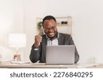 Small photo of Smiling American African makes financial report and studies annual figures, analyzes profits. Accountant checks status of financial