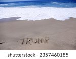 Small photo of TRUMP. Words written in Sand. The Name TRUMP written in the sand on the beach. Trump written in sand with the Ocean in the background. President Donald J. Trump will run for president again. Vote.