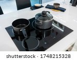 Metal Pot and frying pan on induction hob in modern kitchen. modern kitchen pot cooking induction electrical stove hob concept