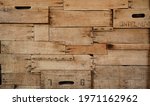 Small photo of Wood background made of old wine crates in a wine cellar with aged texture