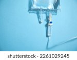 Small photo of Infusion bag in the blue background. IV drip chamber