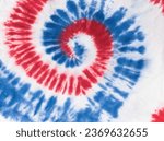 Small photo of Red and blue tie dye pattern on white fabric. Manual dyeing of fabric.