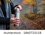 Woman Opening Thermos With Hot...