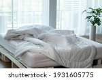 Small photo of Messed bed with white pillow and duvet blanket with natural light in bedroom in the morning, Messy bed after wake up, Messy bed and Cozy Bedroom Concept