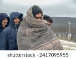 Small photo of Bihac, Bosnia and Herzegovina, 28 December 2020: Group of refugees freezing in food line during cold winter day. Hundreds of migrants freezing in camp Lipa. Inhumane condition. Balkan route.