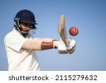 Small photo of A cricketer playing cricket on the pitch in white dress for test matches. Sportsperson hitting a shot on the cricket ball.