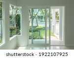 Small photo of Interior atmosphere minimal style design of empty room show white wall with sliding door and glass windows looking through the outdoor garden.