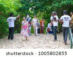 Small photo of DAMBULLA, SRI LANKA - NOV 2016: Obtrusive souvenir dealers propose their goods to tourists on a way to Golden cave temple.