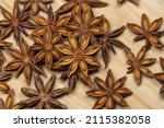 dry anise stars on wooden table.... | Shutterstock . vector #2115382058