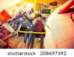 Happy couple riding on ferris wheel at amusement park
