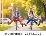 Happy funny young couple riding on bicycle