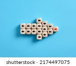 Small photo of Arrow icon made of wooden cubes with the leader and followers pointing opposite directions. Bad leadership concept.