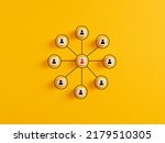 Small photo of Company organizational chart of wooden cubes on yellow background. Human resources management and business concept