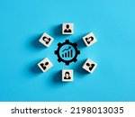 Small photo of Performance improvement, brainstorm, joint efforts to solve problems, teamwork or working on a common project. Ascending graph icon surrounded by wooden cubes with employee symbols.