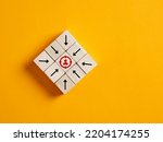 Arrows on wooden cubes pointing towards the focused target customer. Target customer, buyer persona, marketing segmentation or job recruitment concepts.