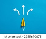 Business decision making and the way to success. Choosing a strategic path to move forward. Alternative options and business solutions. Paper plane with arrows pointing different directions.