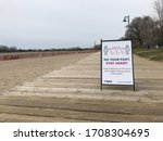 Small photo of TORONTO - APRIL 17, 2020: Stay two meters (the length of three geese) apart new bylaw sign is placed by Toronto government on beach boardwalk to stop spread of COVID-19.