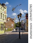 Small photo of POLCZYN ZDROJ, WEST POMERANIAN - POLAND - 2022: Old picturesque townhouses in sunlight with townspeople in the street