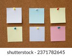 Small photo of collection of colorful variety post note. paper note reminder sticky notes pin paper blue on cork bulletin board. empty space for text.