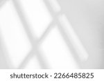 Small photo of Abstract light reflection and grey shadow from window on white wall background. Gray window shadows and sunshine stripe overlay effect for backdrop and mockup design