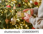 Christmas and New Year expenses.pack of euro money in hands on a Christmas trees background.Spending on gifts and Christmas decor.Expenses during the winter holidays