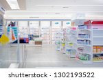 At the chemist, Medicines arranged in shelves, Pharmacy drugstore retail Interior blur abstract background with medicine healthcare product on glass cabinet with neon light.