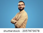 Small photo of Side profile photo of intelligent serious man with arms crossed, strict manager, confident, self-assured, wears beige shirt isolated blue background