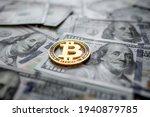 Golden symbolic coin Bitcoin on banknotes of one hundred dollars. Exchange bitcoin cash for a dollars. Cryptocurrency on US dollar bills. Digital modern method of payment. Savings, investments concept