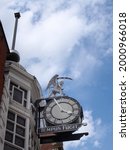 public clock and figure on the historic 19th century time ball building in briggate leeds city centre, the text under the clock is a common latin phrase that translates as time flies