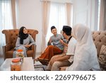 Small photo of Happy young asian muslim couple meeting neighbors at home during eid al fitr celebration