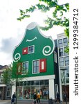 Small photo of Zaandam, Holland - 26/04/2018: Shopping street. Centre of Zaandam. Traditional house. Green house. Cool.