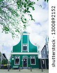 Small photo of Zaanse Schans, Holland - 26/04/2018: Zaanse Schans windmill village in Amsterdam, Holland. Traditional house. Green house.