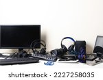 Small photo of Old computers, digital tablets, mobile phones, headphones, many used electronic gadgets devices on white table. E-waste, planned obsolescence, electronic waste for reuse, refurbish and recycle concept