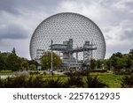 Small photo of Montreal, Quebec, Canada, August 27, 2022: Montreal's famous geodesic dome, the Biosphere, seen in a grey day, at St. Helen's Island.