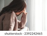A young woman with feeling sad and stressed, sick and headache