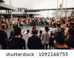 Blur out of focus background of street talent show in public place with a lot of audiences excite and enjoy the show 