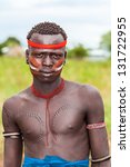 Small photo of ETHIOPIA - AUG 11: Mursi warrior posing in the village,the ethnic groups in the The Omo valley Could disappear Because of Gibe III hydroelectric on dam.Aug 11, 2011 in Omo Valley, Ethiopia.