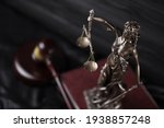 Small photo of The Statue of Justice - lady justice or justitia the Roman goddess of Justice. Statue on brown book with judge gavel. Concept of judicial trial, courtroom process and lawyers occupation