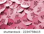 Large amount of yellow stickers with percentage values for black friday or cyber monday sale. Abstract image of discount prices for any goods Image toned in Viva Magenta, color of the 2023 year