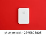 Small photo of KYIV, UKRAINE - OCTOBER 31, 2023 Apple MagSafe battery device for iPhone charging via magnet connection. Mag Safe modern portable power bank device