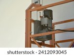 Small photo of Hoist supply and safety lock as part of suspended wire rope platform for facade works on high multistorey buildings. Hoist for elevation, raising or lifting cradle platform