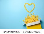 Scattered cornflakes out of box a heart shaped. Dry cereal breakfast. I love cereal. Copy space for text