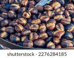 Eat roasted chestnuts. Roasted chestnuts for sale.