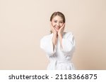 Portrait Beautiful young Asian women happy smile with perfect skin in bathrobe or spa suit on brown isolated studio background.