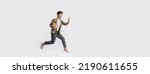 Small photo of Full length handsome Asian man holding box and use smartphone he is run and jumping in air on banner white background. Young male happy excited and using mobile phone with shopping online concept.
