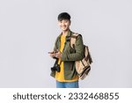 Portrait young Asian man backpacker happy smile in formal shirt using smartphone trading or chatting or online shopping on isolated studio white background. Asian man traveller in studio shot.