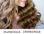 Young woman blond with perfect curls, long hair with curls