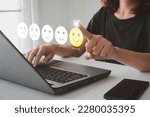 Small photo of Client's hand ticked the happy face smile face, Customer service evaluation and satisfaction survey concept. User give rating to service experience on online application for Customer review feedback.