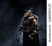 Small photo of Medieval warrior berserk Viking with tattoo with axes attacks enemy. Concept historical photo