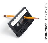 Small photo of Using pencil to spin mangled cassette tape isolated on white background.
